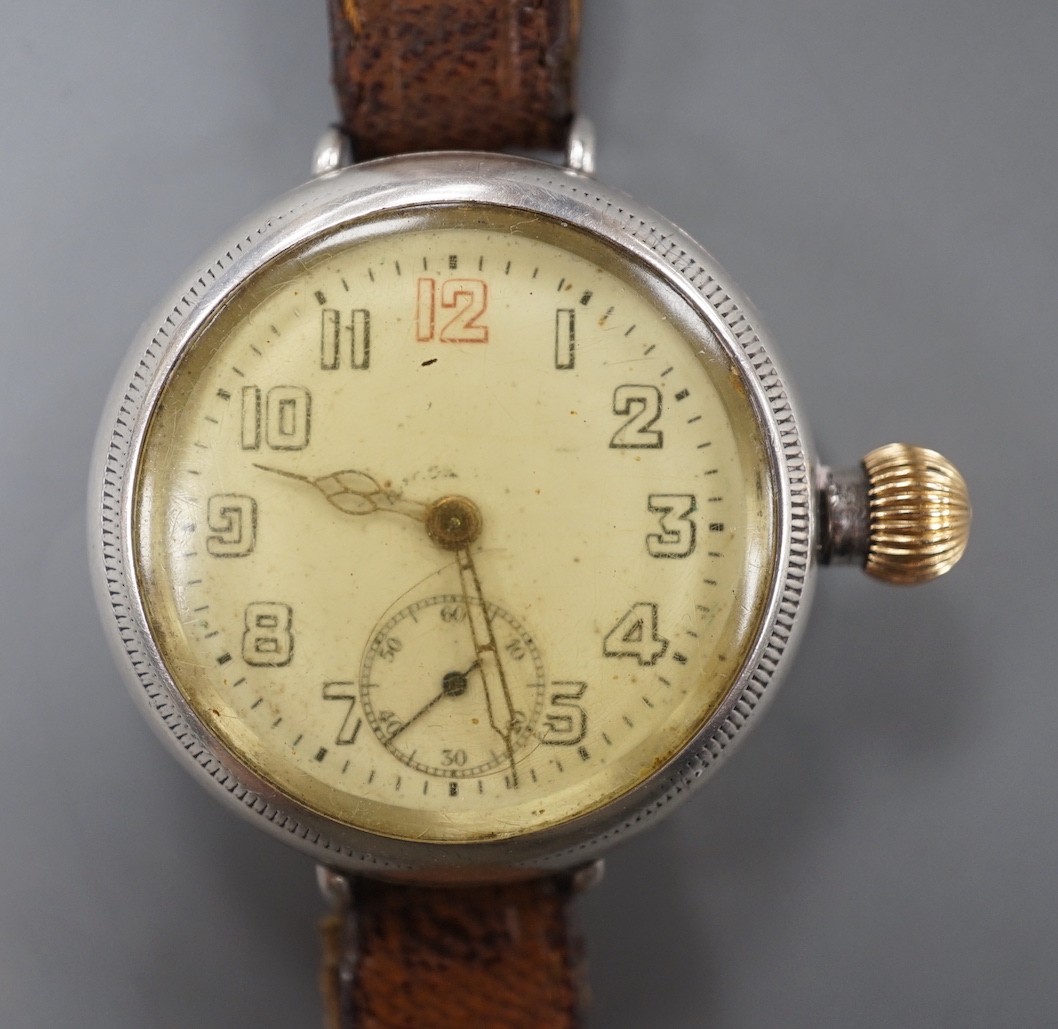 A gentleman's early 20th century silver manual wind wrist watch with Zenith movement, on associated leather strap.